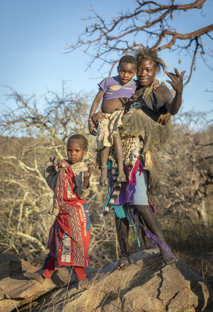 Lake Eyasi, Tanzania, 11th September 2019: Hadzabe man with his kidのeditorial素材