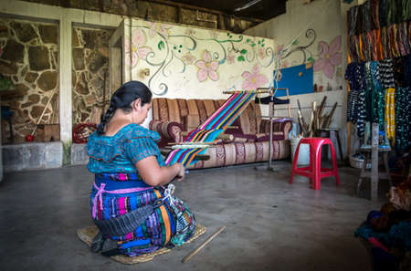 Lake Atitaln, Guatemala, 26th february 2020: mayan woman weaving colorful, traditional fabricsのeditorial素材