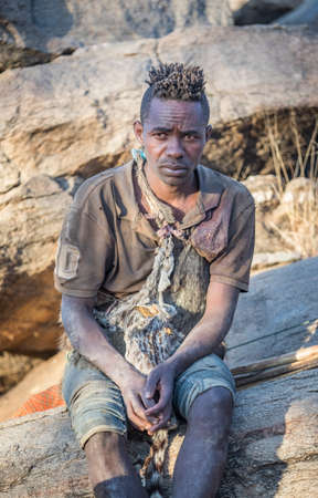 Lake Ayasi, Tanzania, 11th September 2019: hadzabe hunter resting on rocks near his home in natureのeditorial素材