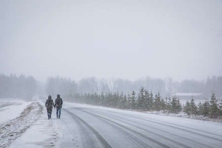 Couple walking hand in hand in a winter landscape in Estoniaの写真素材