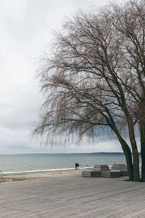 couple walking on a beach in Tallinn during winter season