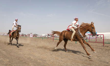Ibri, Oman, 28th April 2018: omani men racing horses to celebrate Eidのeditorial素材