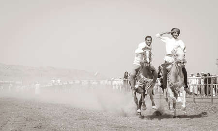 Ibri, Oman, 28th April 2018: omani men racing horses to celebrate Eidのeditorial素材