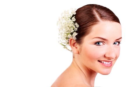 A close up of a beautiful smiling bride looking at the camera in front of a white background.の写真素材