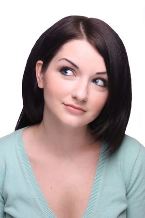 Brunette girl looking to the side knowingly on a white backgroundの写真素材