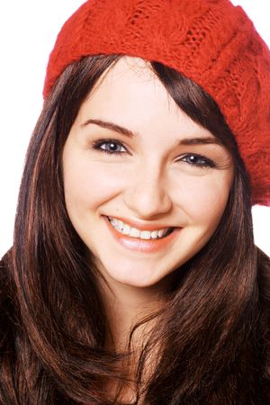 A smiling young woman wearing a red hat, on a white background.の写真素材
