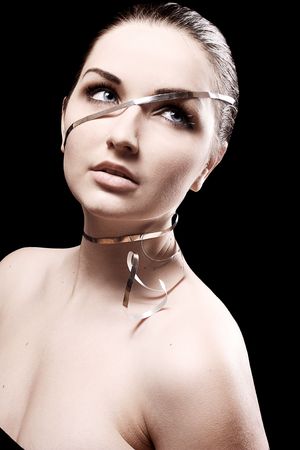 A beauty shot of an attractive young woman wearing ribbon around her head and face.の写真素材