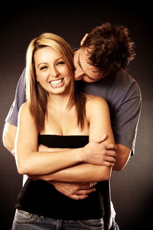 An attractive Couple cuddling and smilingの写真素材