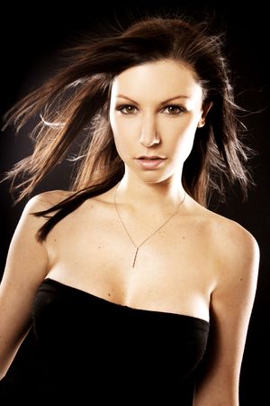 A beautiful young woman in front of a black background.の写真素材