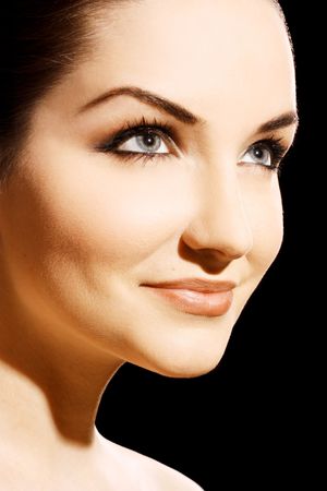 A close up of a beautiful young woman looking away and smiling.の写真素材
