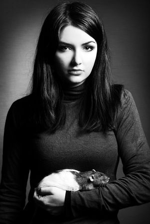 A black and white image of a woman and her pet rat.の写真素材
