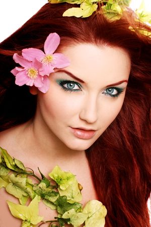 A beautiful young woman with flowers in her hair.の写真素材