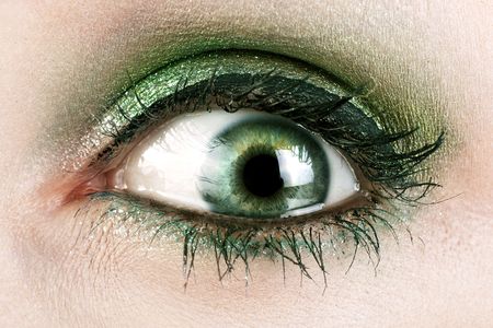 A macro close up of a womans green eye.の写真素材