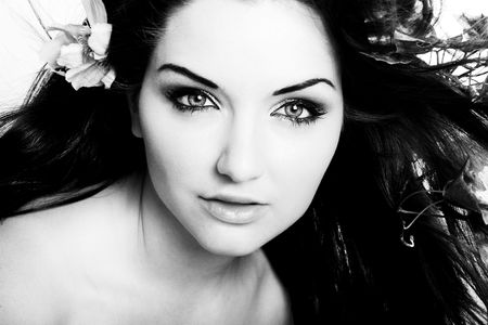 A beautiful young woman with flowers in her hair.の写真素材