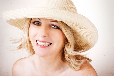 Beautiful middle aged woman wearing a sun hat and smiling.の写真素材
