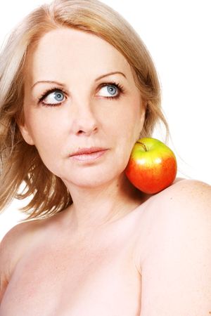 A beautiful middle aged woman with an apple on her shoulder.の写真素材