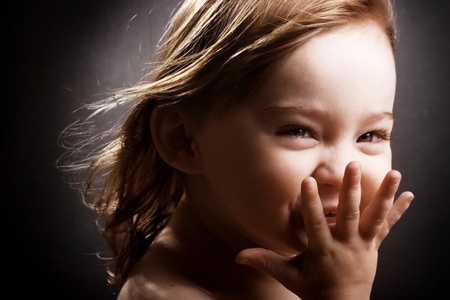A gorgeous little girl giggling hysterically with the wind in her hair.の写真素材