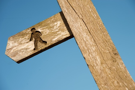 A footpath sign in front of a bright blue sky  Could be used metaphorically の写真素材