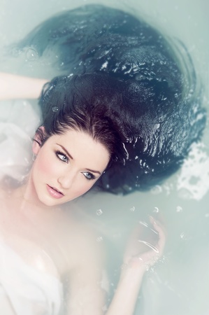 A beautiful brunette submerged in waterの写真素材