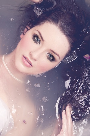 A beautiful brunette submerged in waterの写真素材