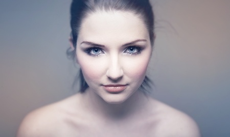 A soft close up of a beautiful brunette looking at the camera.の写真素材