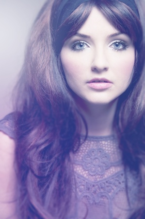 A soft vintage portrait of a brunette in 60's style fashion.の写真素材