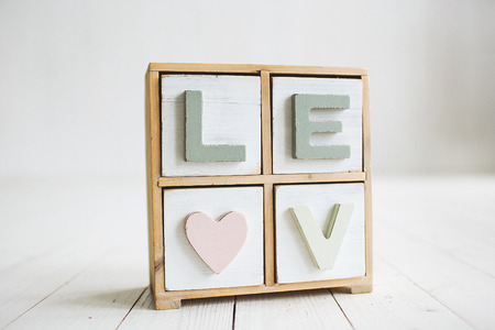 Love decorative vintage letters on the white wooden backgroundの写真素材