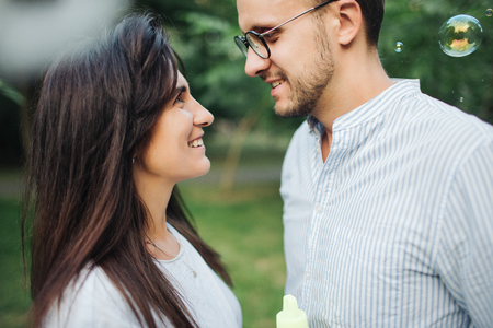 Young pretty couple embrace one another in park outdoorsの写真素材