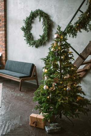 Beautiful holiday decorated loft with Christmas tree with present boxes under itの写真素材