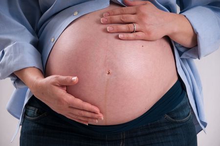 pregnant woman holding her belly