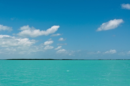 Beautiful turquiose water and blue skies, with island in backgroundの写真素材