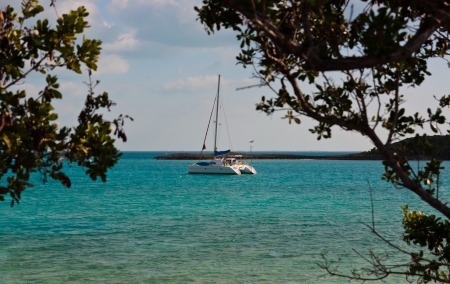 Catamaran sailboat anchored in beautiful turquoise waters in the islands of the bahamas.  copy space availableの写真素材