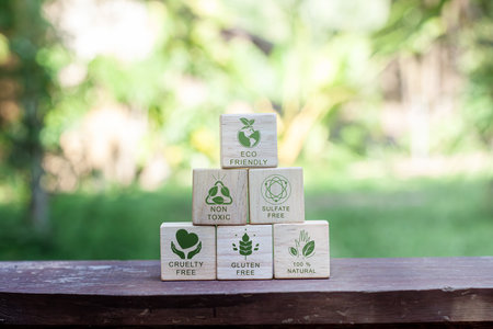 Concept of carbon footprint and reduced carbon emission. Carbon footprint symbols on a wooden cube...