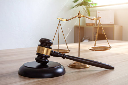 Judge gavel with Justice lawyers having team meeting at law firm in background. Concepts of law.の写真素材