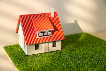 Construction and land law concepts. Judge gavel, scales of justice, open book with house model on wooden tableの写真素材