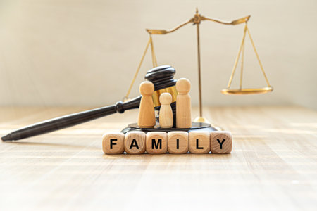 Black cubes with phrase LAW FAMILY and gavel on white tableの写真素材