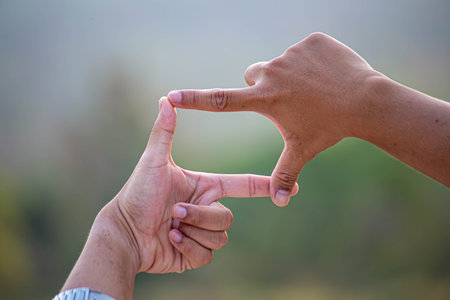 Hands of person making frame distance or symbol in nature.の写真素材