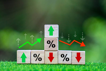 Business and finance concept. Economic and business analysis, risk management. Interest rate, stocks, financial, ranking, mortgage and loan rates. Wooden cubes with percent, up or down arrow icons.の写真素材