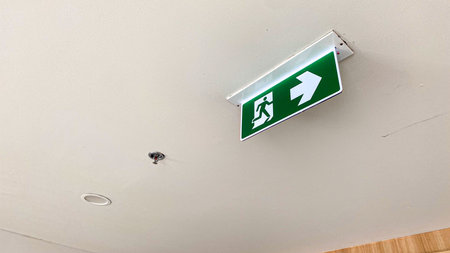 green emergency exit sign on ceilingの写真素材
