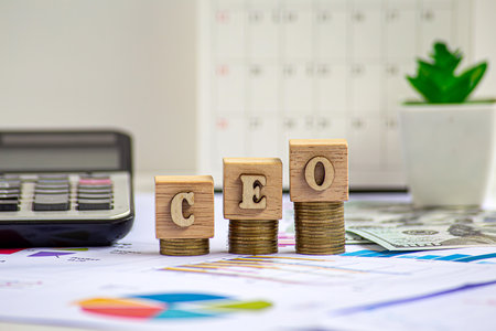 CEO - Chief executive officer symbol. Concept word CEO on wooden cubes. Businessman hand. Beautiful grey background. Business and CEO conceptの写真素材