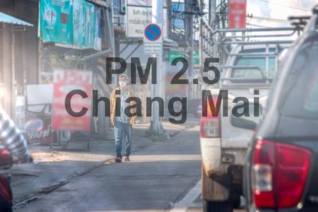 blurry backdrop of Chiang Mai's cityscape filled with burning and smog caused by wildfires during...