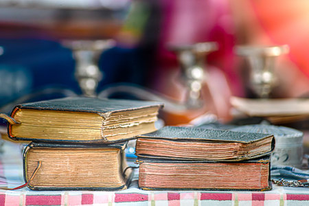 Old antiquarian books stand horizontally in a row. Front view. Selective focus. Square. Close-up.の写真素材