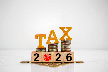 Tax and Vat 2026 Concept.Tax wooden letters on wooden cubes with 2026 on coins. income tax online...
