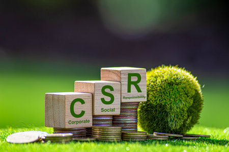 CSR (coporate social responsibility). words CSR on a woodblock and green world on a green background It is an idea for Corporate social responsibility and society activity concept.の写真素材