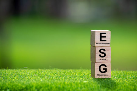 ESG Fund Concept. Esg icons on wooden cubes on a green background.ESG environmental social...