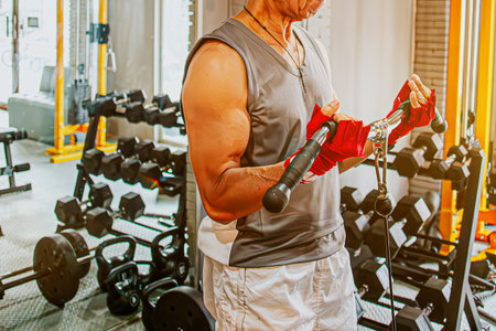 Human Hand holding dumbbell in gym Body builder working out at a gymの写真素材