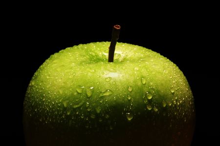 Single green apple on black background.の写真素材