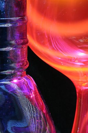 Blue glass vase and an orange bowl in a study of colour and shape.の写真素材