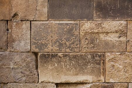 Ancient brick wall background. Big rectangle stone blocks with beautiful texture. Close shot.の写真素材