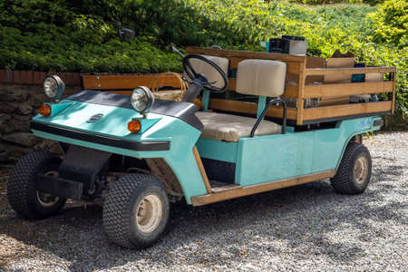A turquoise Melex electric car in Wojslawice Arboretum, Poland. Sunny summer day, 9.07.2021